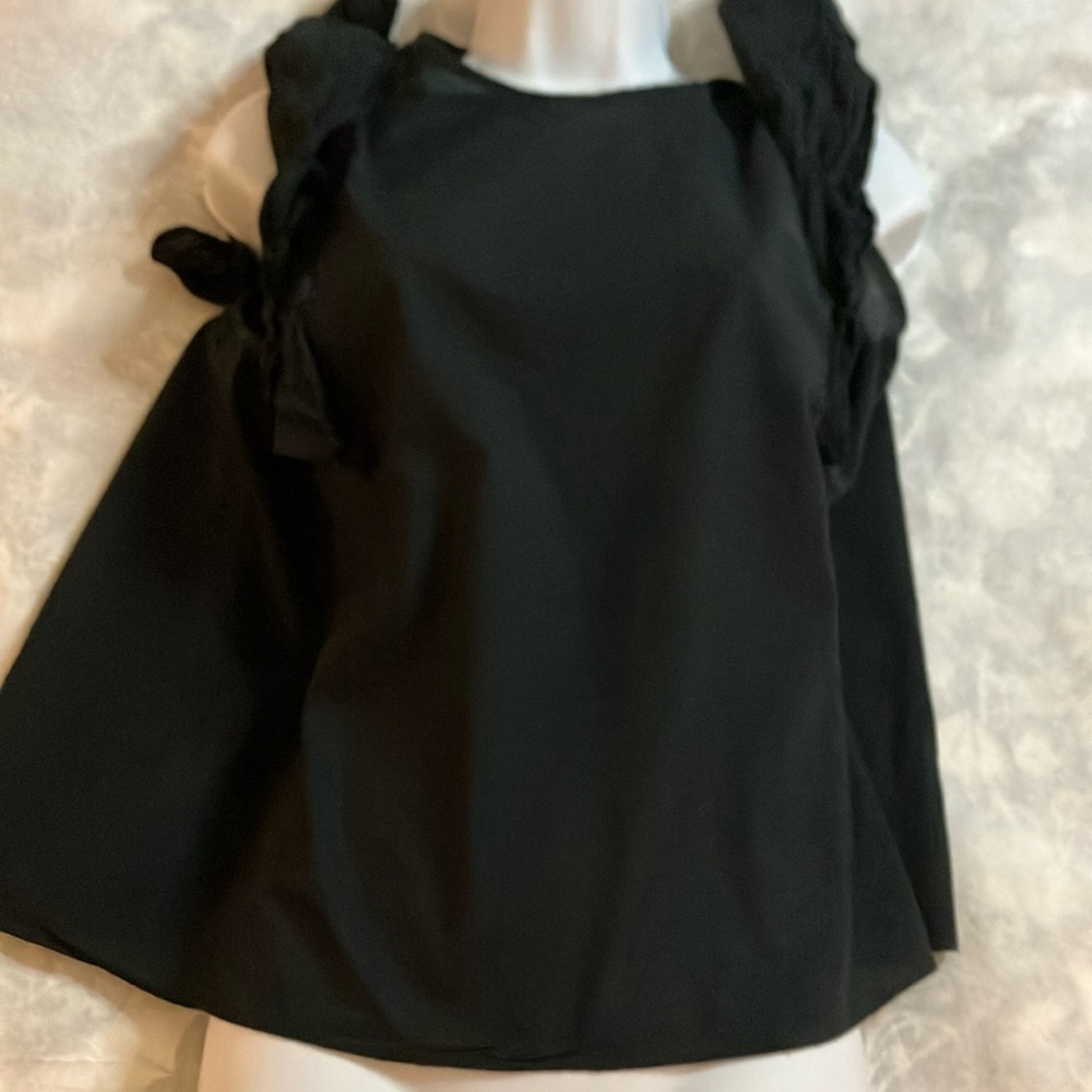 A New Day, black blouse.
